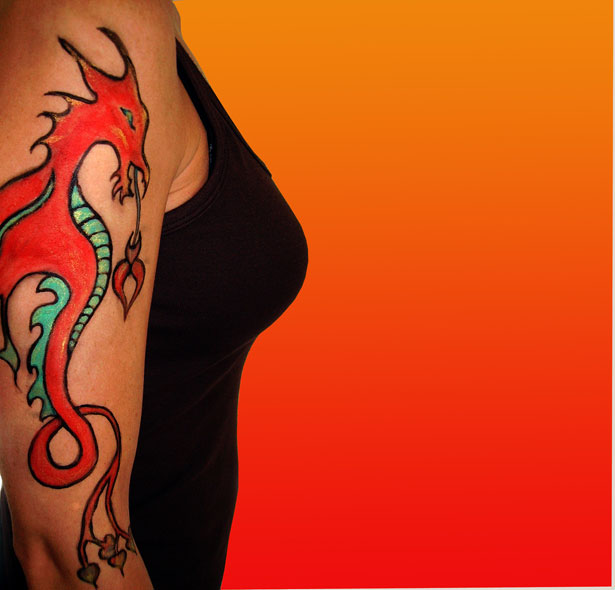Description Lady with dragon tattoo painted on arm