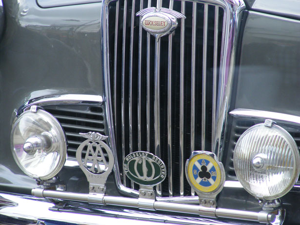 Description Cropped grille of vintage car badges