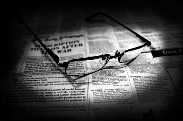 Reading glasses on newspaper
