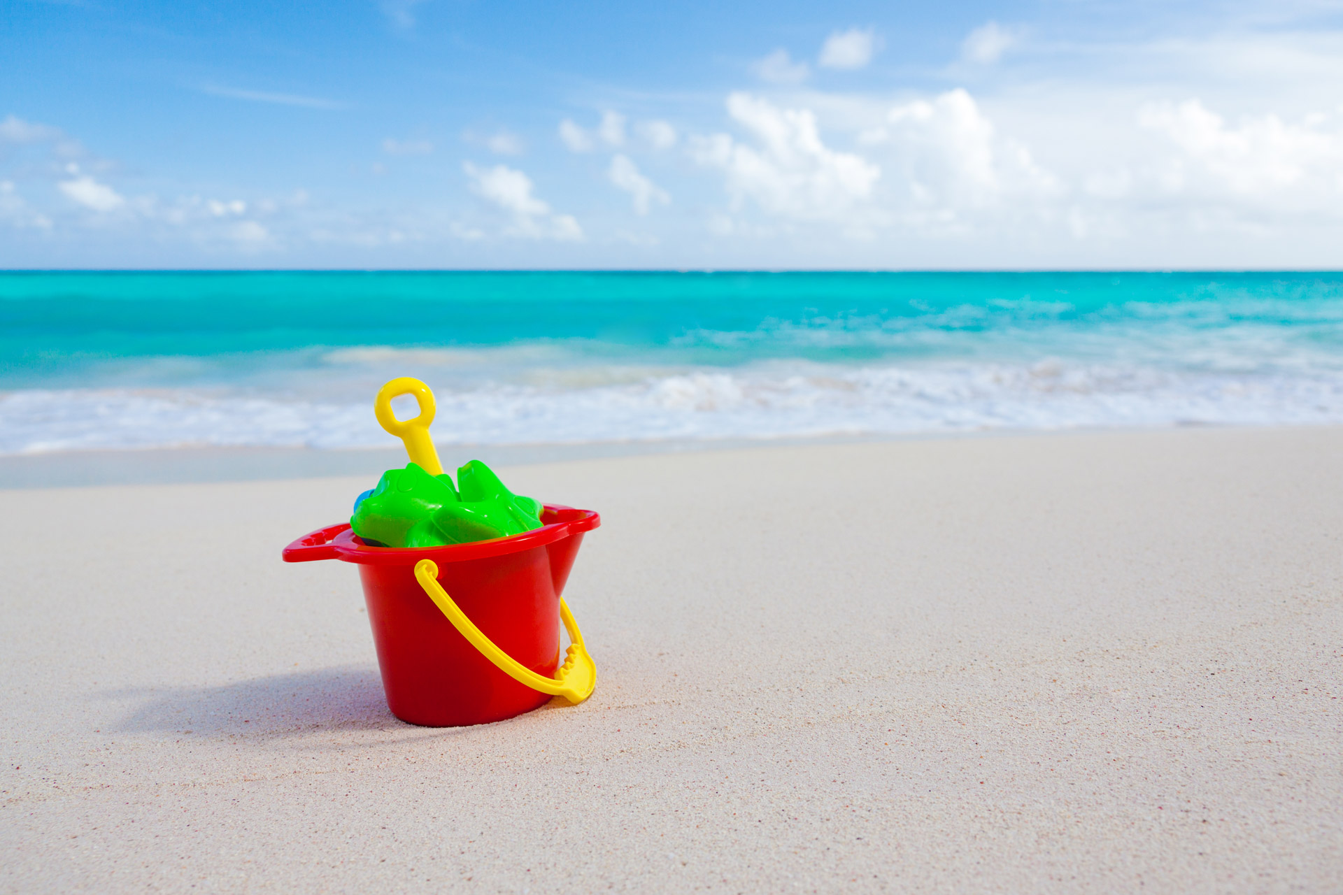 bucket and toys on beach.jpg#.V9fx7gpZygg - How To Survive Bringing Your Kids To The Beach