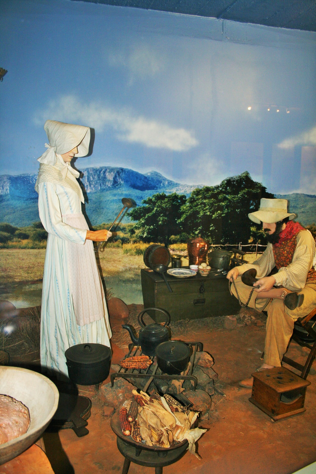 Pioneer Family Cooking On Open Fire