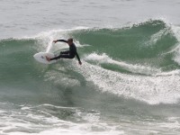 Surfer carves to the wavecrest