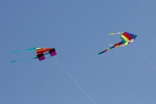 Two Colorful Kites Flying Overhead