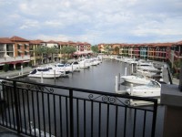 Boats Docked In Canal By Condos
