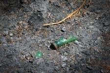 Broken bottle and ashes