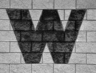 Letter W on brick wall