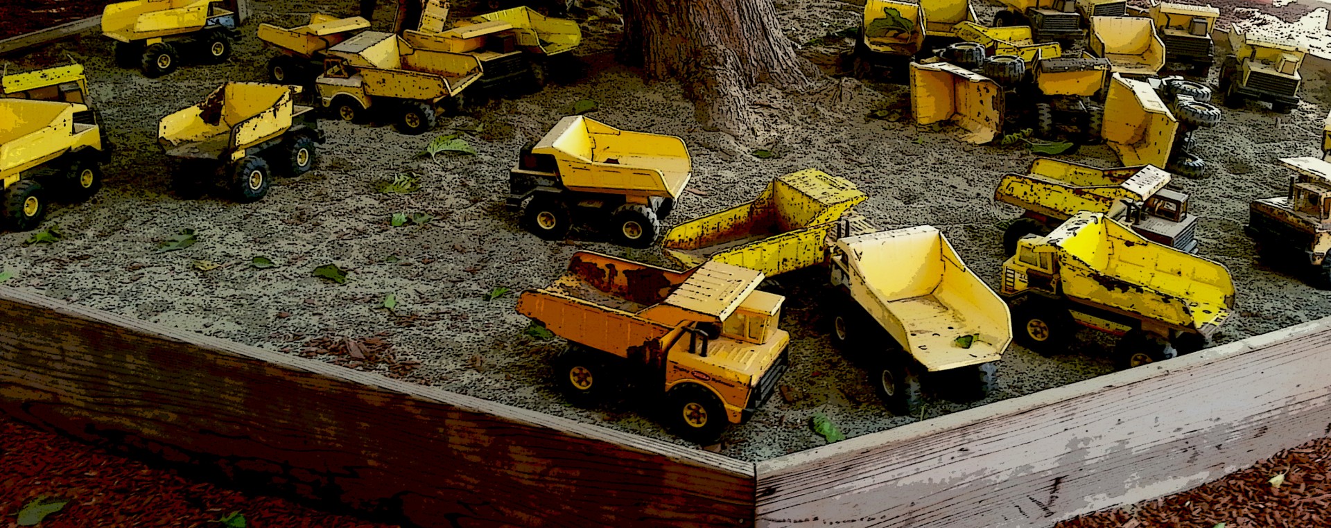 Zandbak van gele speelgoed vrachtwagens