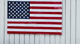 American Flag on White Fence