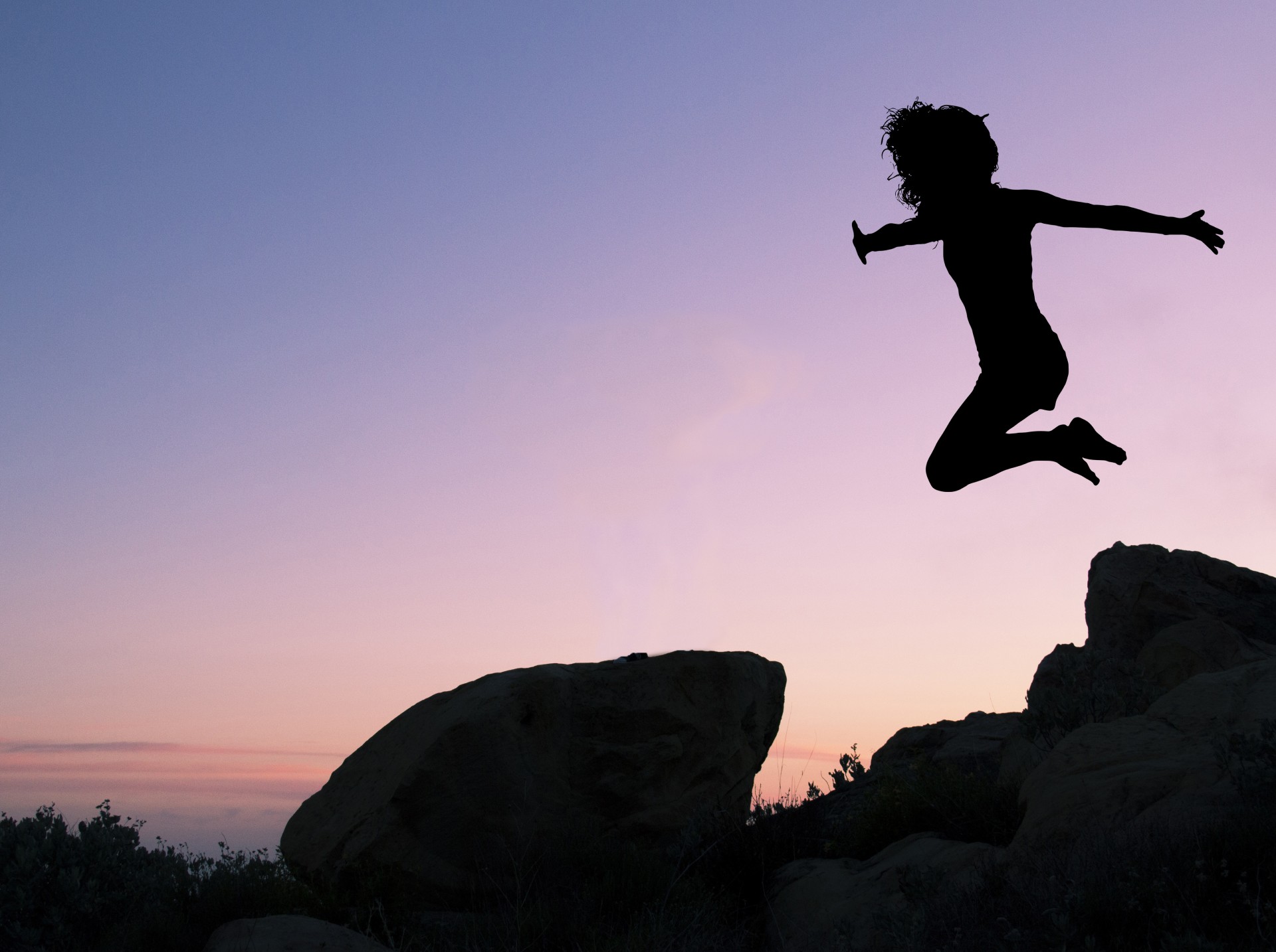 Girl Leaping Off Rock