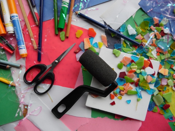 Image of scissors, construction paper, markers, foam roller, and confetti 