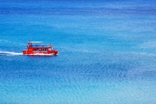 Red boat at sea