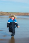 Boy Running On A Beach