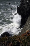 Wave Crashing Against Cliff