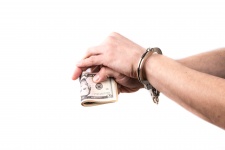 Hands In Handcuffs Hold Money