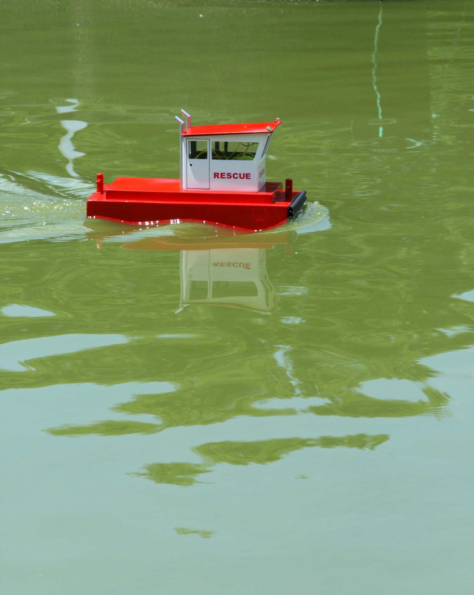 Model Boat Reflecting In Water