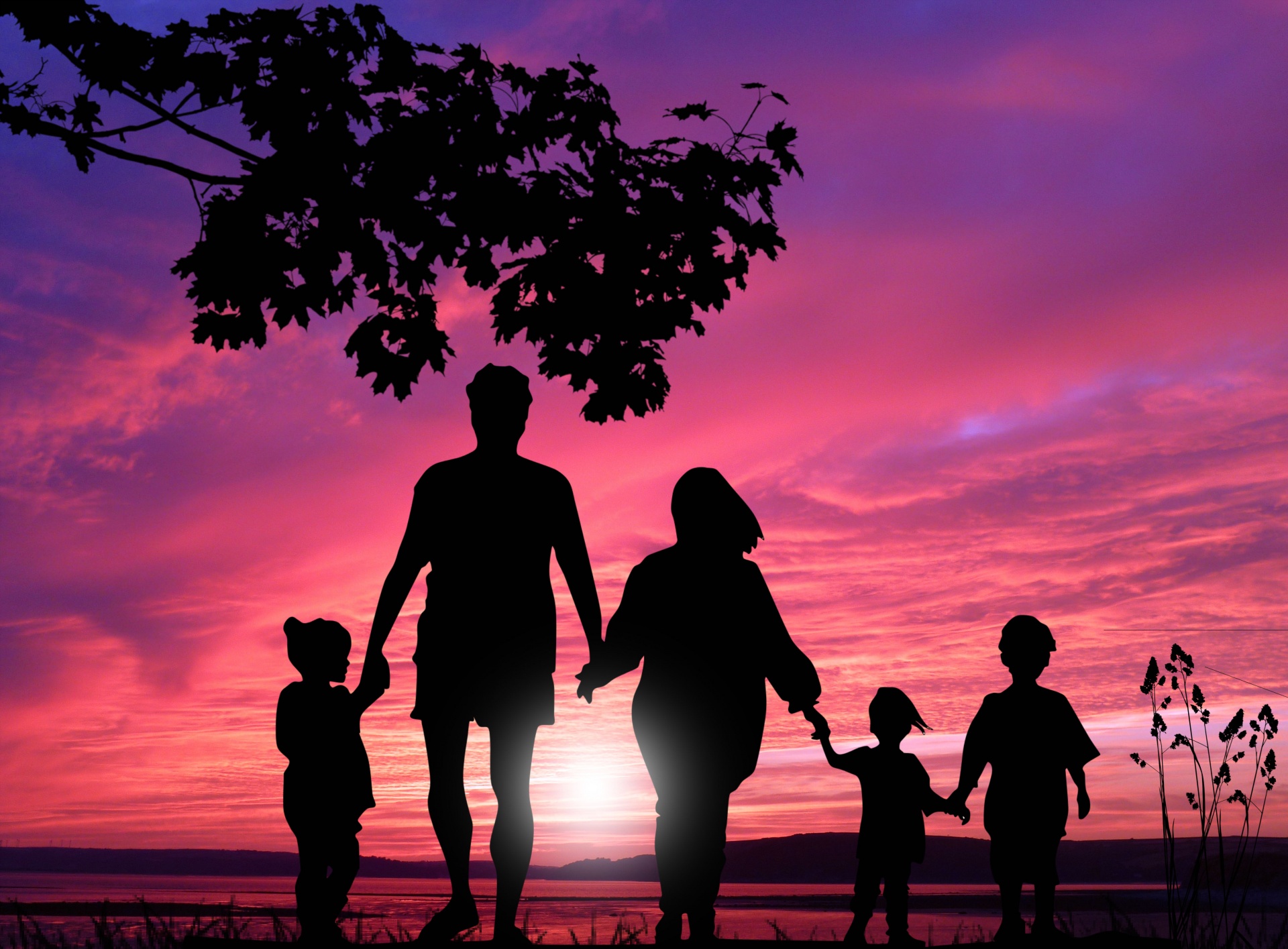 Family Holding Hands During Sunset 
