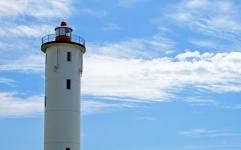 Lighthouse with white cloud in sky