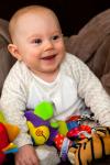 Smiling Baby With Toys