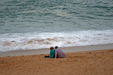 Couple Sitting On Beach