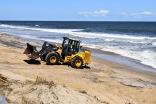 Fork Lift Cleaning Up Beach Debris