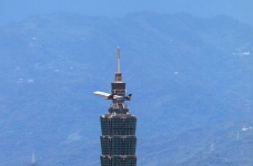 Taipei 101 with plane crossing top