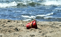 Red Toy Bucket in Sand