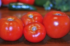 Four Vine-ripe Tomatoes On Table