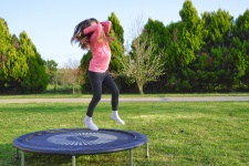 Girl Jumping On Trampoline