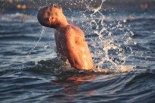 Man Splashing Water Drops In Sea
