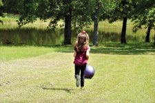 Little Girl Playing With Ball