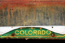 Old License Plate on Rusty Bumper