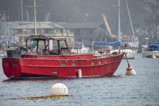 Red Boat Anchored in Bay