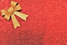 Gold Bow på röd glitter bakgrund