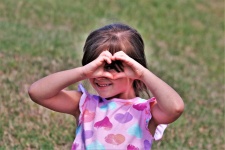 Little Girl Making Heart Gesture