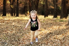 Little Girl Running Through Leaves