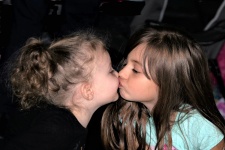 Young Sisters Kissing