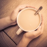 Hands holding a cup of coffee