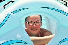 Woman Looking Through Pool Float