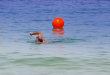 Man swimming in blue ocean