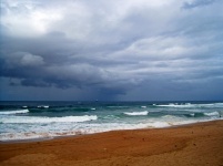 View of beach and sea under clouds