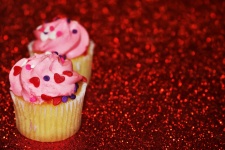 Cupcakes On Red Glitter Background