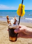 Iced coffee on a beach