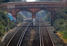 Railroad Tracks Going Under Bridge