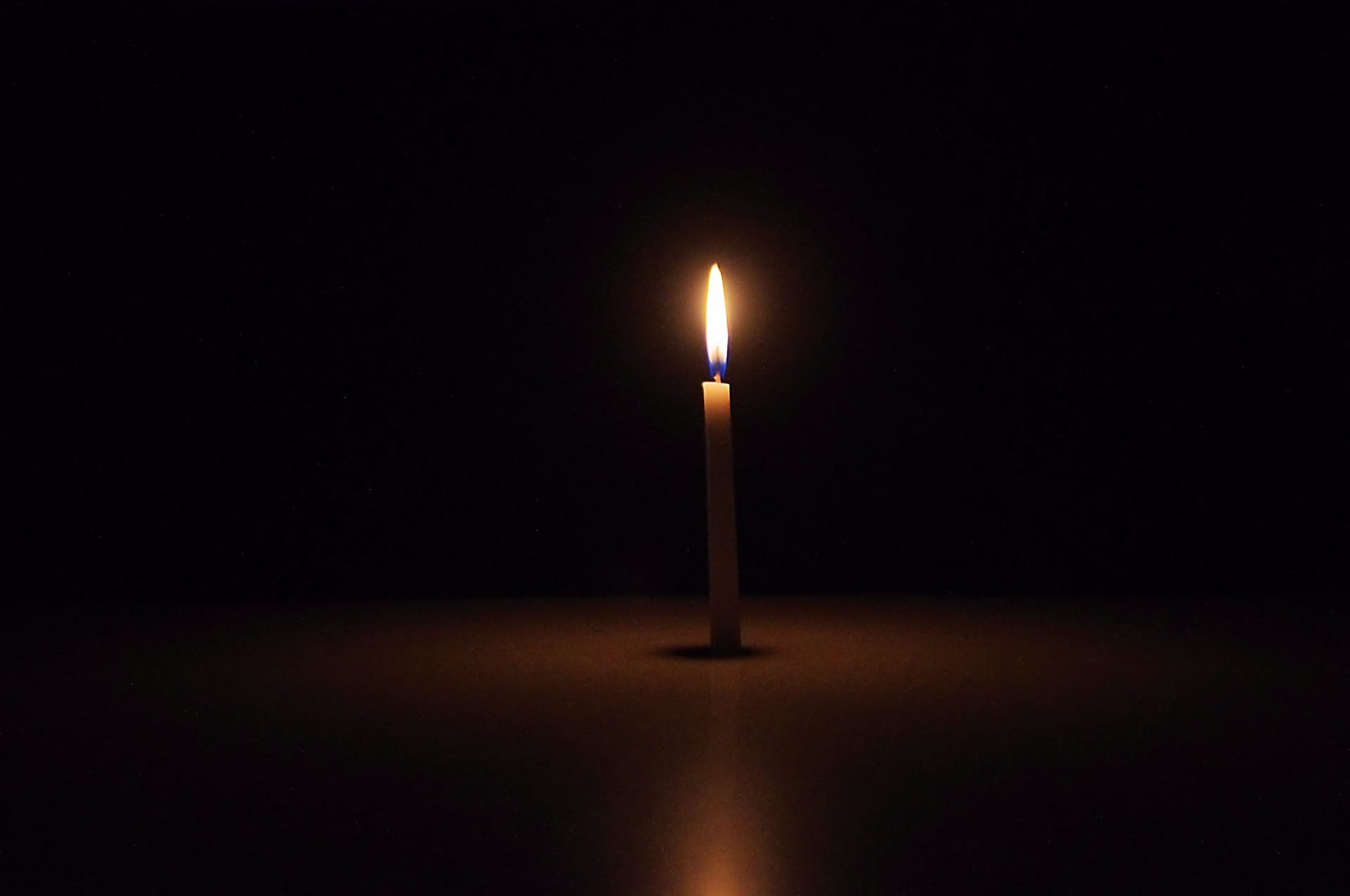 Single Candle In Dark Background