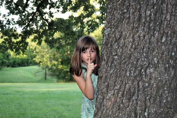 young-girl-hiding-behind-tree.jpg