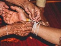 Hands Of Elderly Holding Hand Of Younger