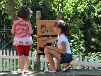 Little Girls Reading Sign At Zoo