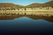 Reflection Of Hill And Blue Sky