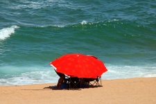 Red brollie on the beach