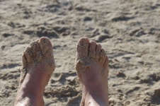Sand Covered Feet At Beach